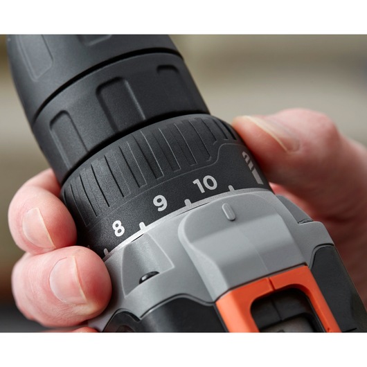 Close-up photo of a hand adjusting BLACK+DECKER BCD002C2K cordless drill torque settings.