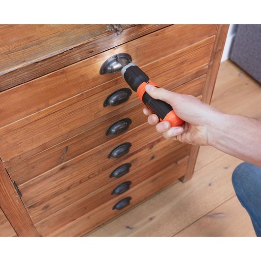 Photo of BLACKDECKER BCF601C cordless screwdriver being used on a drawer handle.