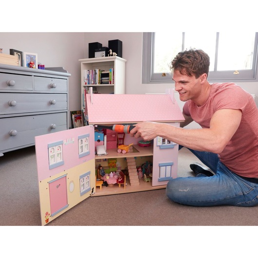 BLACKDECKER BCF603C cordless screwdriver used for assembling a dollhouse, indoor side angle.