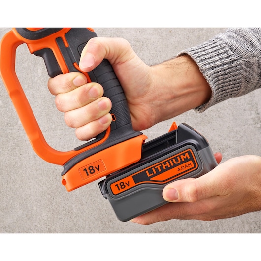 BLACKDECKER BCG720M1 18V lithium battery being inserted into power tool, close-up side view.