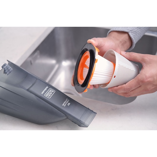 Photo of BLACKDECKER BCHV001C1 handheld vacuum with filter being removed, shown near a sink.