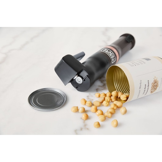 BLACKDECKER BCKM1011KGF electric can opener on countertop with open can of chickpeas and detached lid.