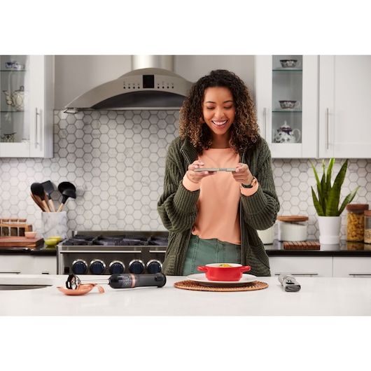 BLACKDECKER BCKM1011KGF kitchen tool set on countertop with utensils and red dish, kitchen background.