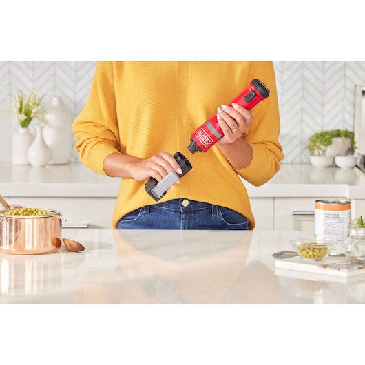 Photo of BLACKDECKER BCKM1012KR cordless kitchen tool in use, red design, kitchen setting.