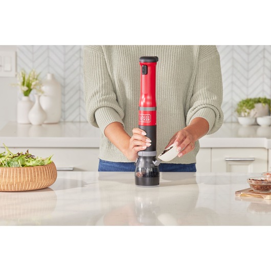 BLACKDECKER BCKM1012KR red and black cordless spice mill used in modern kitchen.