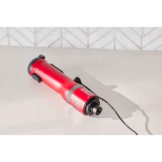 Photo of BLACKDECKER BCKM1012KR red rotary tool on countertop, cord attached, with white tile background.