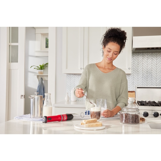 Photo of BLACKDECKER BCKM1012KR cordless milk frother on kitchen counter with coffee, bread, and milk.