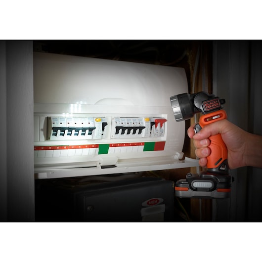 Photo of BLACKDECKER BDCK123S2S cordless flashlight illuminating electrical circuit panel.