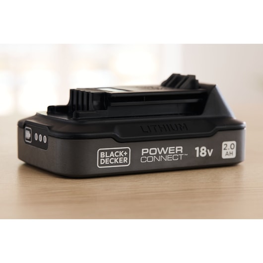 Photo of BLACK+DECKER BDL2018S lithium 18V 2.0Ah Power Connect battery, angled side view on wooden surface.