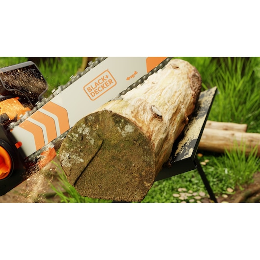 Photo of BLACK+DECKER BECS1835 chainsaw cutting a tree log outdoors, orange and white bar visible with sawdust flying.