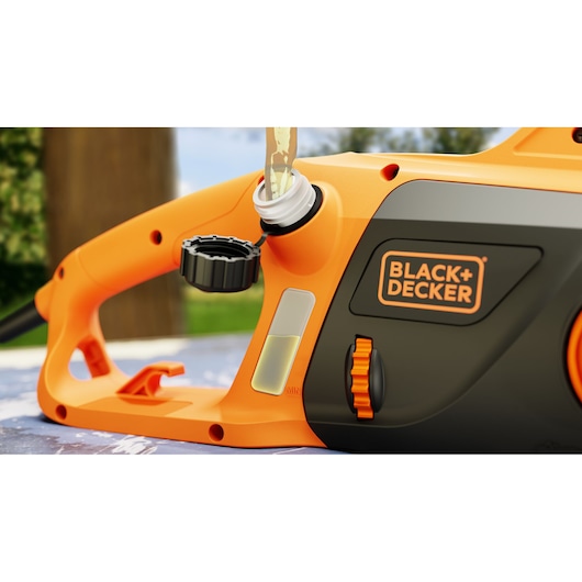 Close-up photo of BLACK+DECKER electric chainsaw BECS2245, showing oil reservoir being filled, orange and black color.