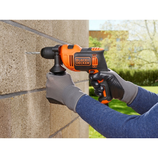 Photo of BLACKDECKER BEH710 corded hammer drill used on exterior brick wall.