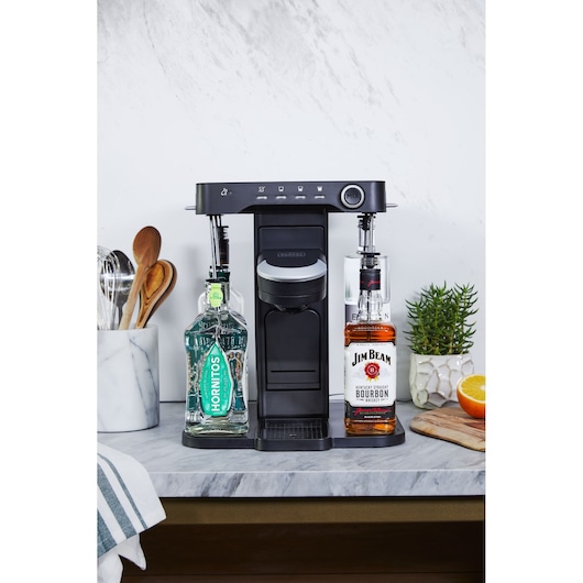 BLACKDECKER BEHB101 black cocktail maker with digital controls, shown front angle on kitchen counter with liquor bottles.