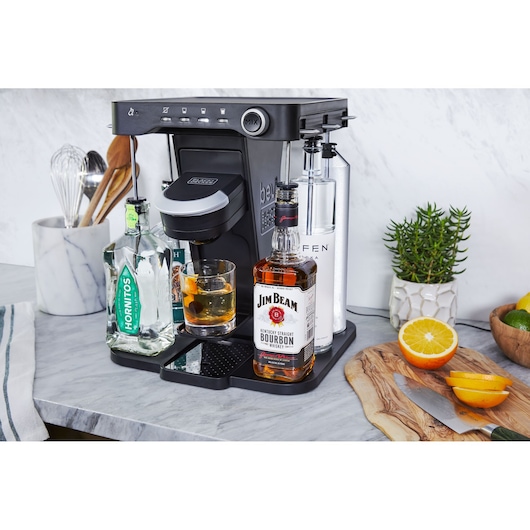 BLACKDECKER BEHB101 cocktail maker on kitchen counter with bottles and a glass, angled front view.