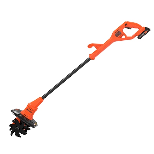 A BLACK+DECKER cordless garden tiller, with an orange and black design, featuring a long handle and rotating blades at the base.