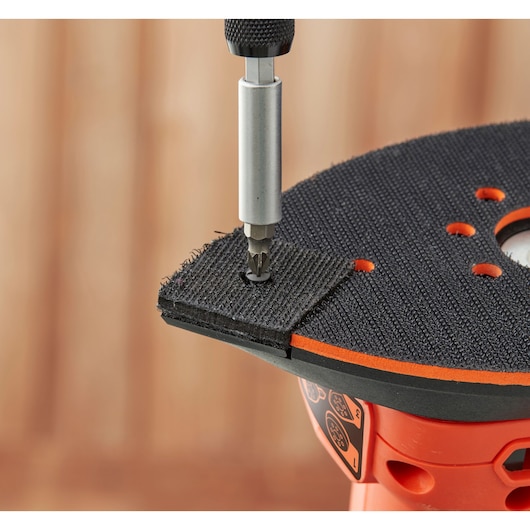 Close-up of BLACKDECKER BEW200K detail sander with screwdriver attaching black sandpaper pad.