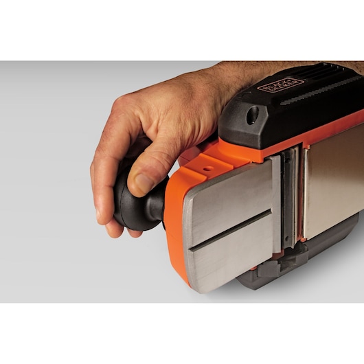 Close-up side view of BLACK+DECKER BEW712 electric planer with hand gripping black front handle.