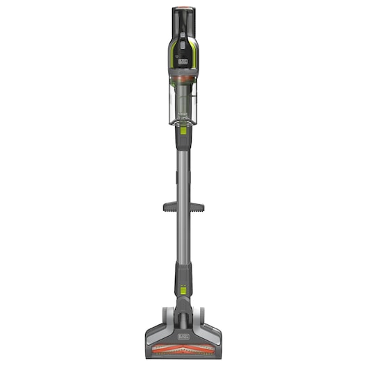 A BLACK+DECKER cordless stick vacuum cleaner with a grey body, orange detailing, a transparent dust container, and a wide floor head, shown upright against a white background.