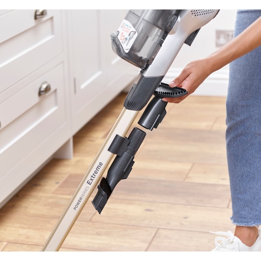 BLACKDECKER BHFEV36B2DW cordless vacuum cleaner with attachments on stick, close-up in kitchen.