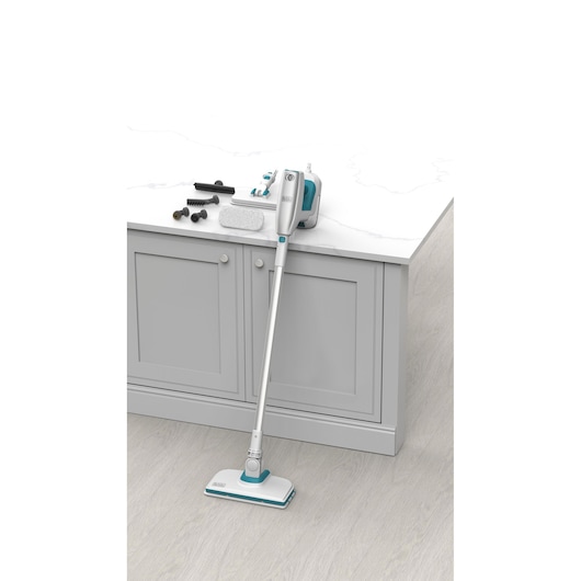 BLACKDECKER BHSM15FX10 steam mop with white and teal body, accessories displayed on countertop, front angle.