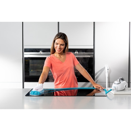 BLACKDECKER BHSM1615DSG steam cleaner on kitchen counter with person cleaning stovetop using blue and white handheld attachment.