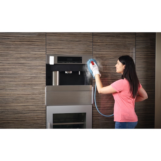 BLACKDECKER BHSM1615DSM steam cleaner glove used on built-in kitchen appliance.