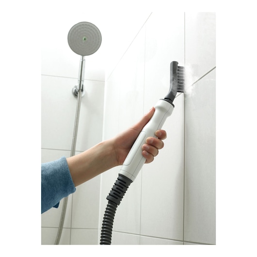 BLACKDECKER BHSM1615DSM steam cleaner with brush cleaning shower tile grout in bathroom.