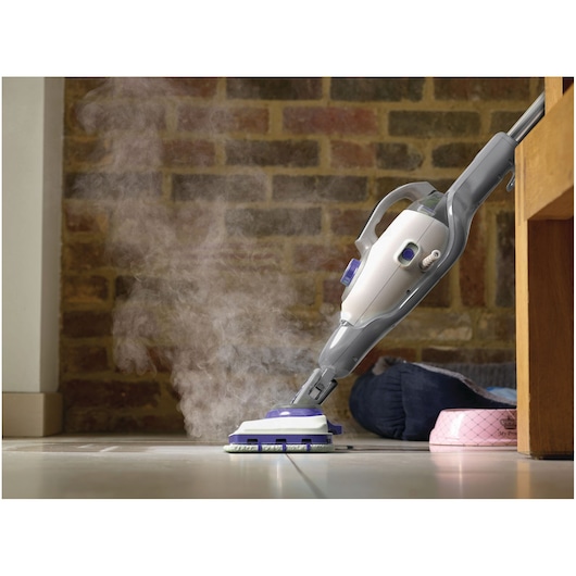 Photo of BLACKDECKER BHSM1615DSM steam mop cleaning tiled floor, visible steam and ergonomic grey handle.