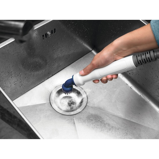 Photo of BLACK+DECKER BHSM166DSM steam cleaner cleaning a stainless steel sink drain.