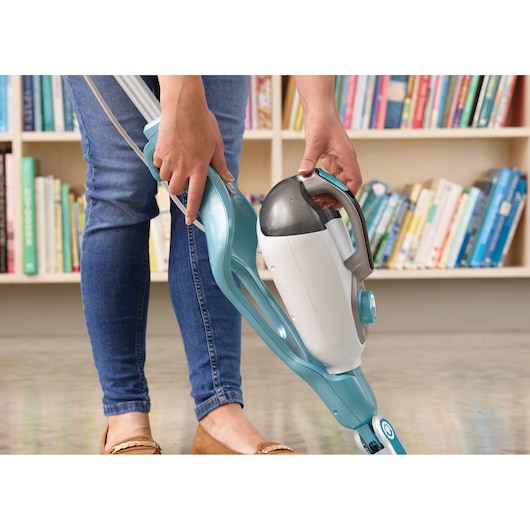 BLACKDECKER BHSM166DSM steam mop with detachable handheld unit, light blue and white, in use indoors.