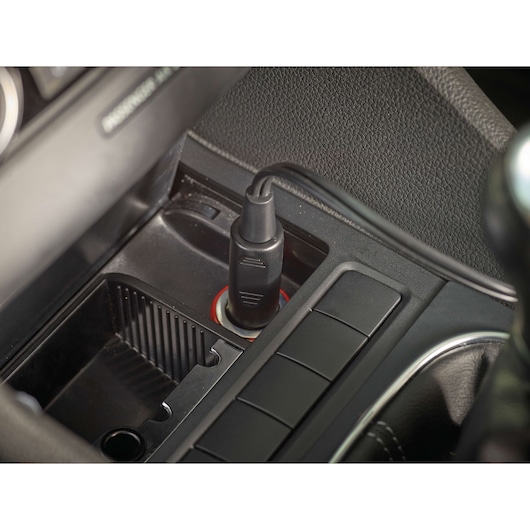 BLACKDECKER PV1200AV car vacuum cleaner power adapter plugged into a vehicle 12V socket, close-up view.