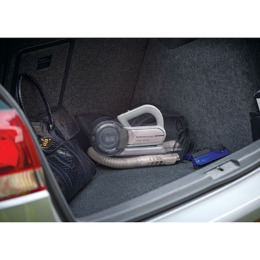BLACKDECKER PV1820LRGP handheld vacuum in car trunk with hose and carrying bag.