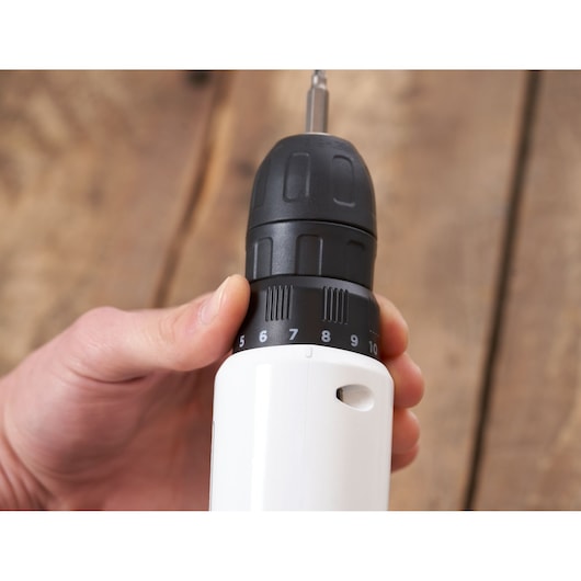 Photo of BLACKDECKER REVDD12C cordless drill with adjustable torque, close-up of grip and black chuck.