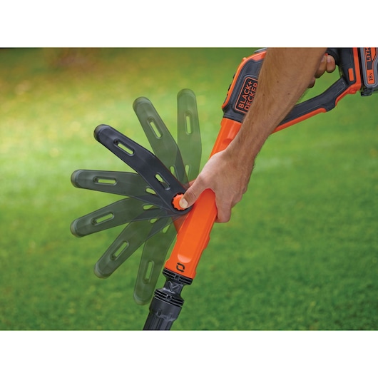 BLACK+DECKER STC1840EPC grass trimmer handle adjustment feature shown outdoors.