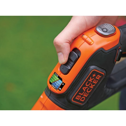 Photo of BLACK+DECKER STC1840EPC orange and black trimmer handle with speed control switch and ECO/TURBO label.
