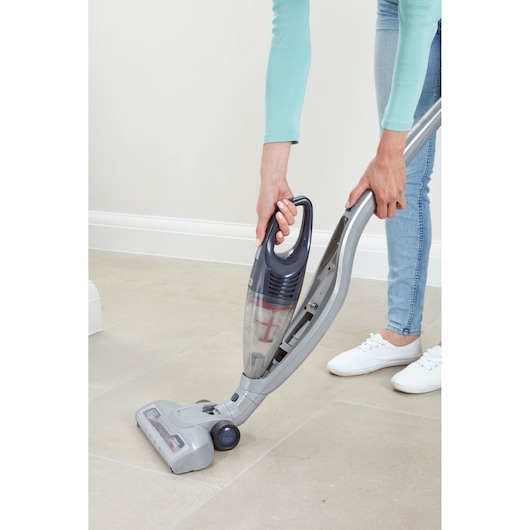 Photo of BLACKDECKER SVB520JW cordless stick vacuum being used on a light tile floor.