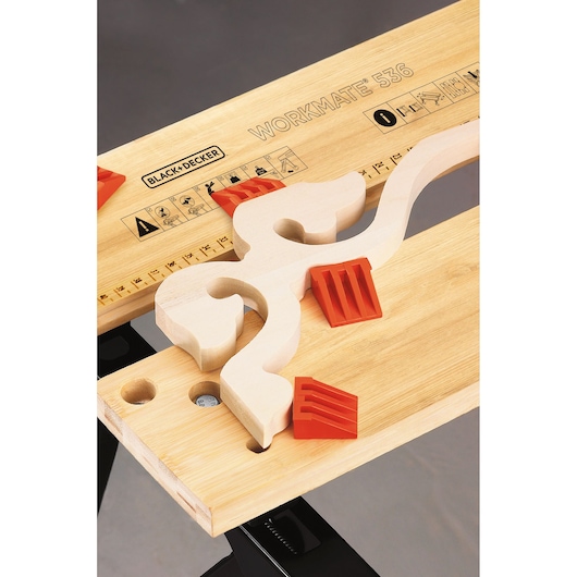 BLACKDECKER WM536 photography of Workmate 536 workbench with wooden material and orange clamps, top view.